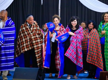 Leaders celebrating in traditional shukas