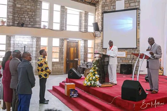 A bishop laying hands on a minister in prayer