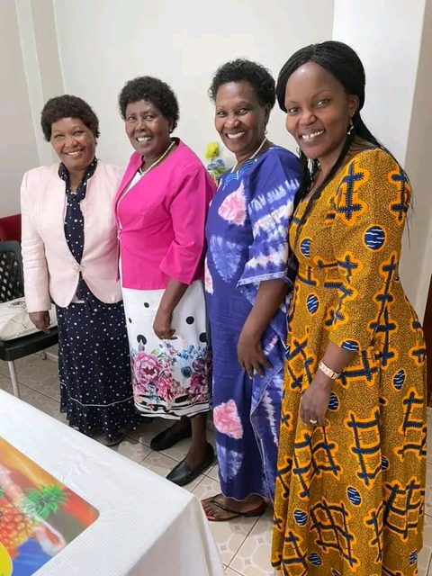Four women standing together smiling