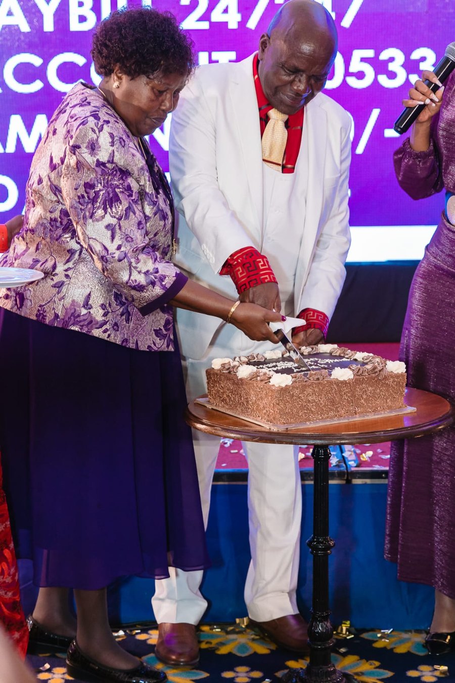Bishop Dr William Tuimising and Rev. Rebecca cutting the cake