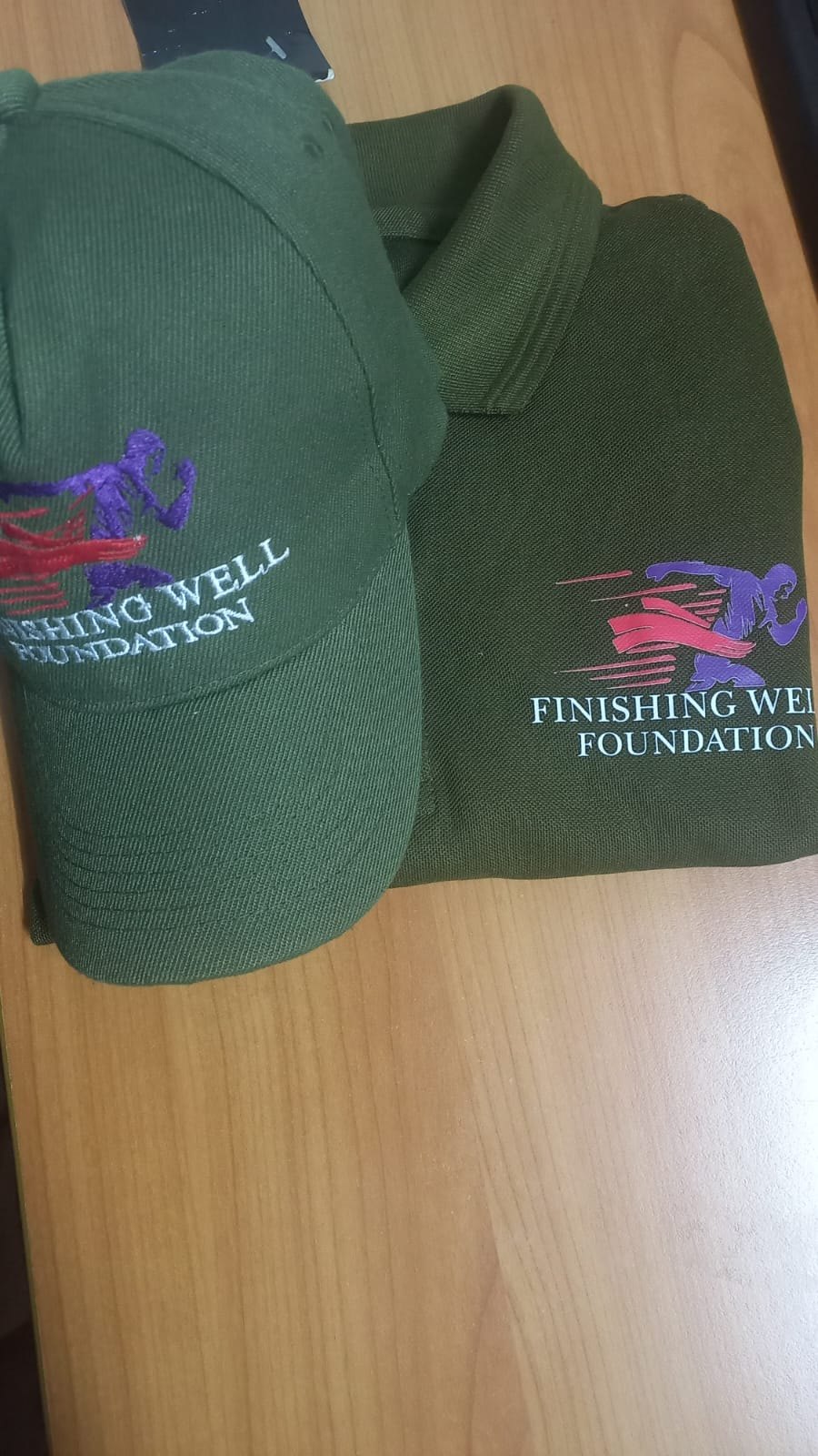 Finishing Well Foundation embroidered cap and polo shirt