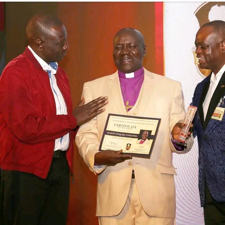 Bishop Tuimising receiving a national honor certificate
